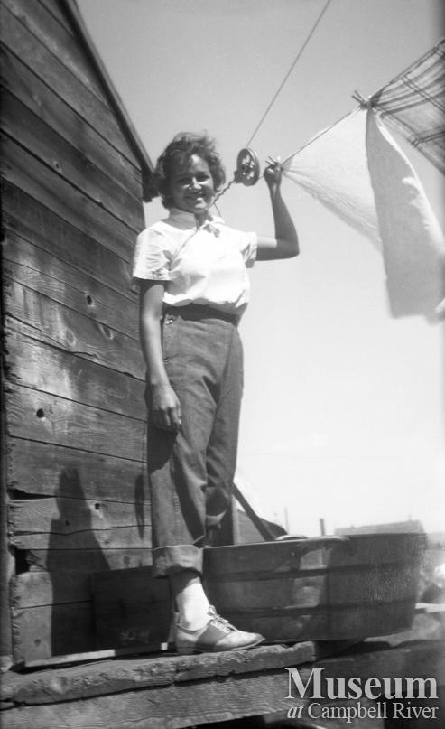 Mary Henderson hanging laundry