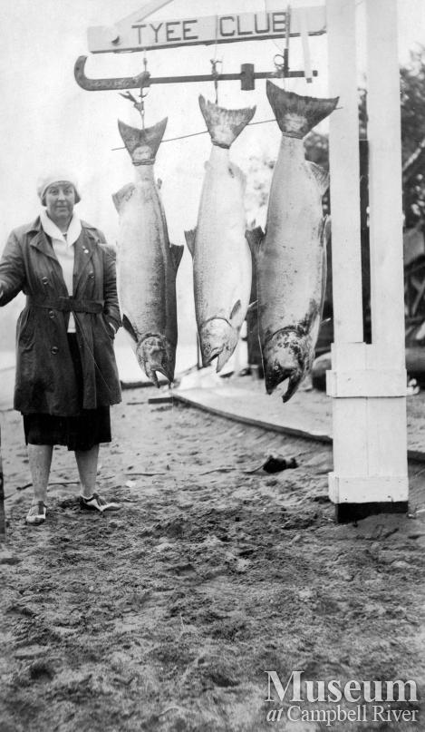 Unidentified woman with salmon at Tyee Club scale