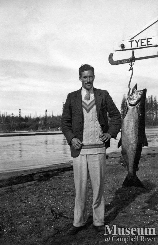Unidentified man with fish at Tyee Club scale