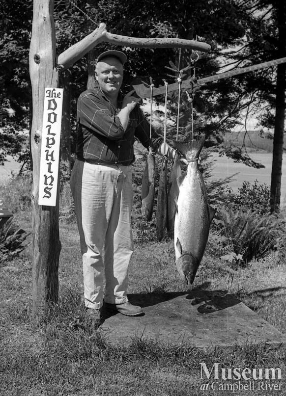 Fisherman with catch of salmon at Dolphin's Resort