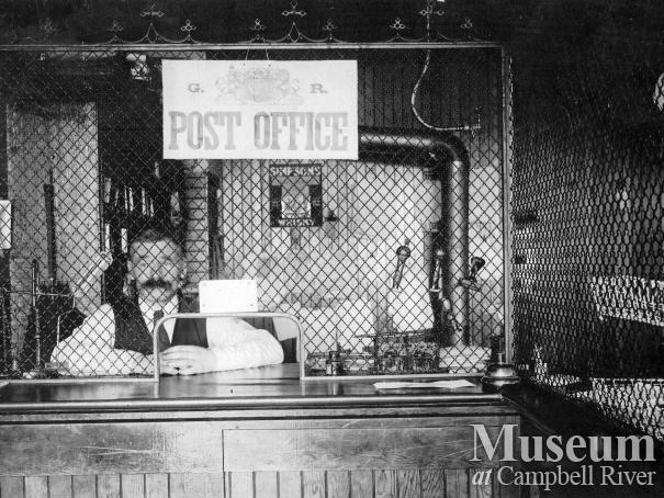 Mr. Hardy, Assistant Postmaster, inside the Post Office