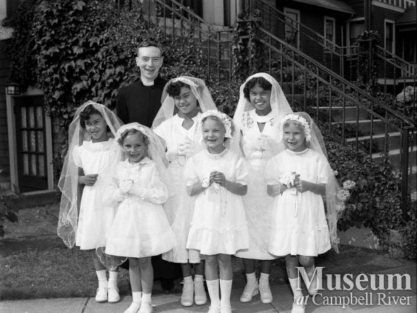 Priest with group of girls being confirmed 
