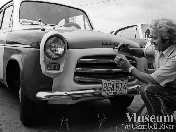 Carihi principal John Young touching up his new car