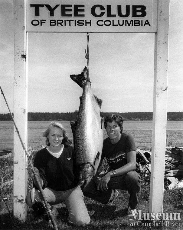 Unknown man and woman anglers with fish