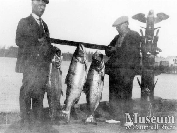 Two male anglers with three fish