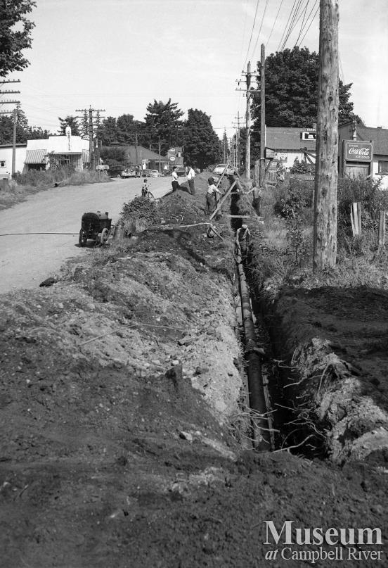 Installing the waterline along the Island Hwy at Campbellton